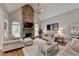 Inviting living room features a stone fireplace, high ceilings, neutral colors, and ample seating at 7050 Redcliff Ct, Suwanee, GA 30024