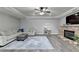 This living room boasts a stone fireplace, recessed lighting, and neutral color palette at 7050 Redcliff Ct, Suwanee, GA 30024