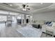 Open-concept living room with recessed lighting, hardwood floors, and contemporary furnishings at 7050 Redcliff Ct, Suwanee, GA 30024