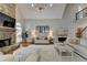 Bright living room boasts a stone fireplace, lots of seating, and hardwood floors at 7050 Redcliff Ct, Suwanee, GA 30024