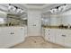 Spacious main bathroom with double vanities, granite countertops, and tile flooring at 7050 Redcliff Ct, Suwanee, GA 30024
