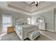 Serene main bedroom boasts tray ceilings, soft carpeting, and abundant natural light at 7050 Redcliff Ct, Suwanee, GA 30024