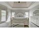 Bright main bedroom with tray ceiling and neutral tones at 7050 Redcliff Ct, Suwanee, GA 30024