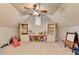 Spacious playroom featuring carpeted floors, custom built-ins, and natural light; an ideal area for  at 7050 Redcliff Ct, Suwanee, GA 30024