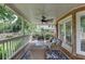 Relaxing covered porch with wicker furniture and an overhead fan; a delightful outdoor living space at 7050 Redcliff Ct, Suwanee, GA 30024