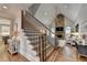 Elegant staircase leading to the living room, featuring wood treads and iron spindles at 7050 Redcliff Ct, Suwanee, GA 30024