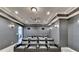 Finished home theater featuring a large screen, projector, tiered seating, and sconce lighting at 7050 Redcliff Ct, Suwanee, GA 30024