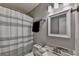 Bright bathroom featuring a shower with a striped curtain and a vanity with a marbled countertop at 1132 Owen Cir, Sugar Hill, GA 30518