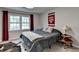 Bedroom featuring a comfortable bed, and a window offering natural light and view at 1132 Owen Cir, Sugar Hill, GA 30518