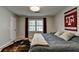 Bedroom featuring a comfortable bed, carpeted floor, and a window offering natural light at 1132 Owen Cir, Sugar Hill, GA 30518
