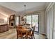 Cozy dining area with wood table, fireplace and sliding glass door leading to outdoor deck at 1132 Owen Cir, Sugar Hill, GA 30518