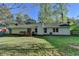 Back exterior view of home showcasing siding, deck, and spacious backyard with mature trees at 1132 Owen Cir, Sugar Hill, GA 30518
