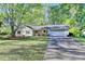 Charming ranch-style home featuring a well-maintained front yard, driveway, and two-car garage at 1132 Owen Cir, Sugar Hill, GA 30518