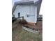 View of the exterior of the house with a garden bed and lush greenery at 1132 Owen Cir, Sugar Hill, GA 30518