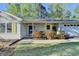 Inviting front entrance with yellow shutters, blue door, and manicured landscaping at 1132 Owen Cir, Sugar Hill, GA 30518