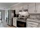 Bright kitchen with granite counters, stainless steel appliances, and updated cabinets at 1132 Owen Cir, Sugar Hill, GA 30518