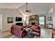 Cozy living room with stone fireplace, vaulted ceilings, and comfortable leather seating at 1132 Owen Cir, Sugar Hill, GA 30518