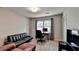 Living room featuring a sofa, desk, and chair, perfect for a home office or study area at 1132 Owen Cir, Sugar Hill, GA 30518