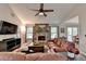 Comfortable living room featuring a stone fireplace, vaulted ceilings, and an open layout at 1132 Owen Cir, Sugar Hill, GA 30518