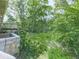 Lush backyard featuring a stone border and deck with privacy from trees, creating a serene outdoor space at 1527 Keeter Rd, Canton, GA 30114