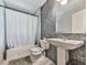 Bathroom featuring a pedestal sink, and a bathtub with shower, and a tiled floor at 1527 Keeter Rd, Canton, GA 30114