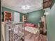 Cozy bedroom featuring wood floors, two bookshelves, and a neutral rug for a warm feel at 1527 Keeter Rd, Canton, GA 30114