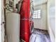 Laundry area featuring a stacked washer and dryer along with a hot water heater at 1527 Keeter Rd, Canton, GA 30114