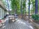 Spacious wooden back deck with a pergola, wooden railing, outdoor furniture, and forest view at 1017 Fairway Valley Dr, Woodstock, GA 30189