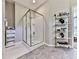 Bathroom featuring a glass-enclosed shower and a shelving unit for storage at 1017 Fairway Valley Dr, Woodstock, GA 30189