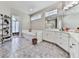 Spacious bathroom featuring a corner tub, white cabinets, and tile floors at 1017 Fairway Valley Dr, Woodstock, GA 30189