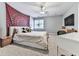 Cozy bedroom with a large tapestry, ceiling fan, and a mounted TV at 1017 Fairway Valley Dr, Woodstock, GA 30189