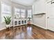 Bright dining area with a built-in display cabinet, hardwood floors, and three large windows providing ample natural light at 1017 Fairway Valley Dr, Woodstock, GA 30189