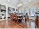 Dining room featuring a chandelier, large windows, hardwood floors, and view into living area at 1017 Fairway Valley Dr, Woodstock, GA 30189