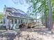 Rear exterior view of home featuring a deck, gray siding, and wooded backdrop at 1017 Fairway Valley Dr, Woodstock, GA 30189