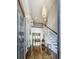 Bright foyer featuring hardwood floors, a staircase, a stylish chandelier, and a view of the living room at 1017 Fairway Valley Dr, Woodstock, GA 30189