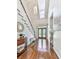 Bright foyer featuring hardwood floors, a staircase, a stylish chandelier, and a view of the front door at 1017 Fairway Valley Dr, Woodstock, GA 30189