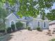 Charming home features stone accents, manicured landscaping, and a neatly maintained lawn at 1017 Fairway Valley Dr, Woodstock, GA 30189
