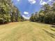 Scenic view of the golf course's fairway surrounded by mature trees and greenery at 1017 Fairway Valley Dr, Woodstock, GA 30189