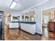 Open kitchen with stainless steel appliances, granite countertops, white cabinets, and hardwood floors at 1017 Fairway Valley Dr, Woodstock, GA 30189
