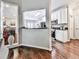 Kitchen view featuring white cabinets, dark countertops, stainless steel appliances, and hardwood floors at 1017 Fairway Valley Dr, Woodstock, GA 30189