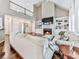 Comfortable living room with high ceilings, hardwood floors, a fireplace, built-in shelves, and large windows at 1017 Fairway Valley Dr, Woodstock, GA 30189