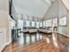 Bright living room with hardwood floors, a fireplace, large windows, and an adjacent dining room at 1017 Fairway Valley Dr, Woodstock, GA 30189