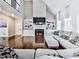 Cozy living room with high ceilings, hardwood floors, a fireplace, built-in shelves, and large windows at 1017 Fairway Valley Dr, Woodstock, GA 30189
