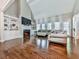 Spacious living room with high ceilings, hardwood floors, a fireplace, and large windows at 1017 Fairway Valley Dr, Woodstock, GA 30189