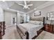 Spacious main bedroom with carpeted floors, tray ceiling, and large windows at 1017 Fairway Valley Dr, Woodstock, GA 30189