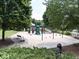 Community playground with swings, slides, and play structures surrounded by trees at 1017 Fairway Valley Dr, Woodstock, GA 30189