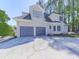 Two-story home featuring an attached two-car garage and well maintained lawn at 1017 Fairway Valley Dr, Woodstock, GA 30189