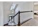Staircase featuring wood rails and a modern chandelier at 1017 Fairway Valley Dr, Woodstock, GA 30189