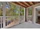 Covered outdoor balcony with a view of nature, and a door to the living area at 110 Barrington Hills Dr # 110, Atlanta, GA 30350