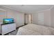 Bright bedroom with a soft bed, dresser with television, and closet at 110 Barrington Hills Dr # 110, Atlanta, GA 30350